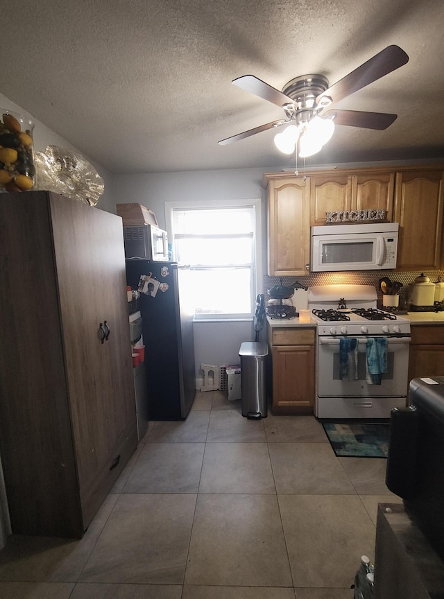 kitchen featuring light tile patterned floors, white appliances, decorative backsplash, and a textured ceiling