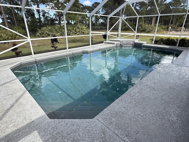 outdoor pool with glass enclosure and a patio area