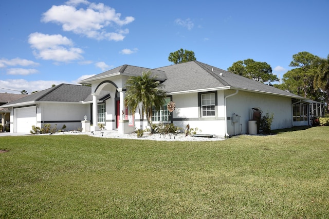 ranch-style home with a shingled roof, a front lawn, a garage, and stucco siding