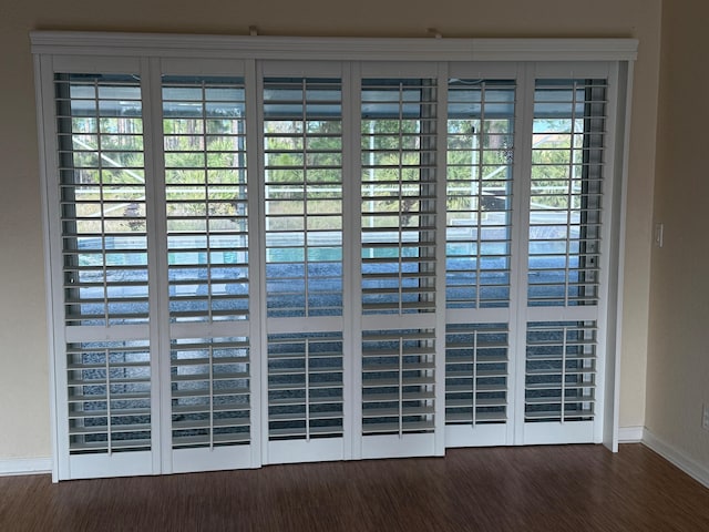 details featuring baseboards and wood finished floors