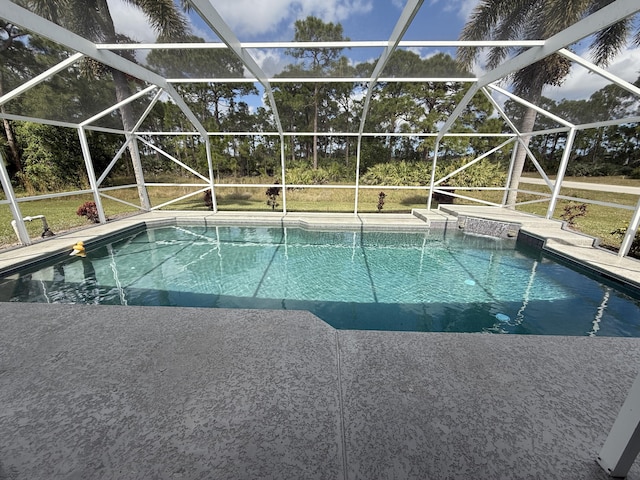 outdoor pool with a patio area and glass enclosure