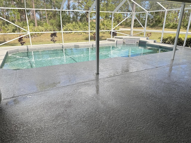 outdoor pool with a patio area and a lanai