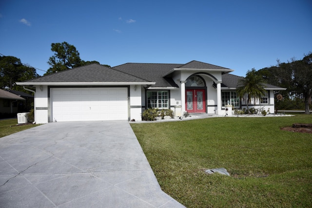 single story home featuring a garage, a front yard, french doors, and stucco siding