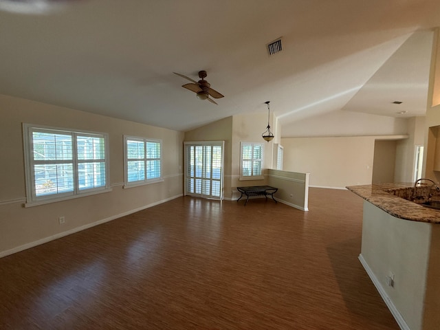 unfurnished living room featuring lofted ceiling, visible vents, dark wood finished floors, and a ceiling fan