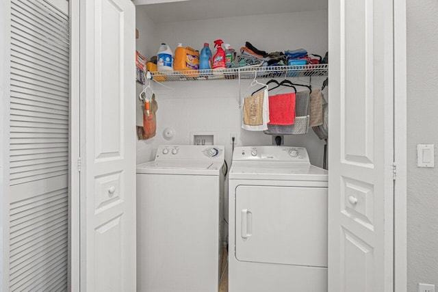 clothes washing area featuring separate washer and dryer