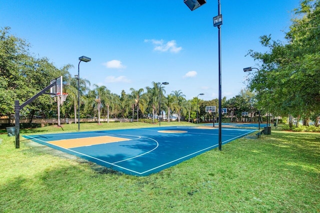 view of sport court with a yard