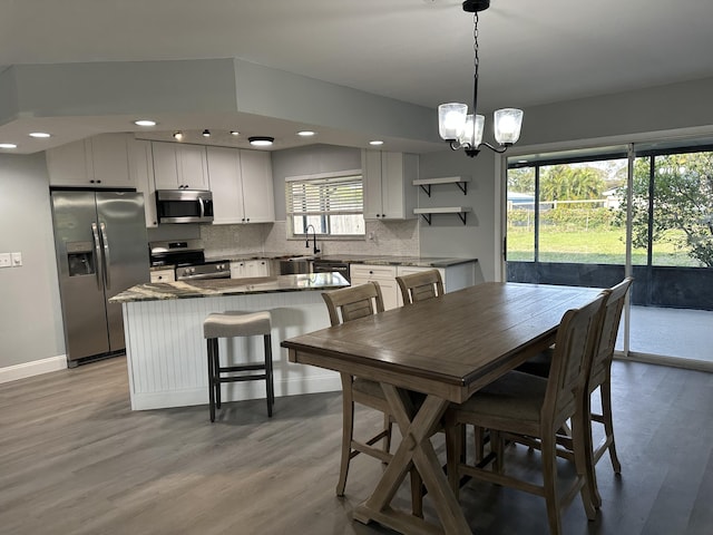 dining space with a chandelier and light hardwood / wood-style floors