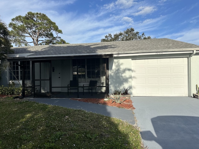 ranch-style house featuring a garage and a front lawn