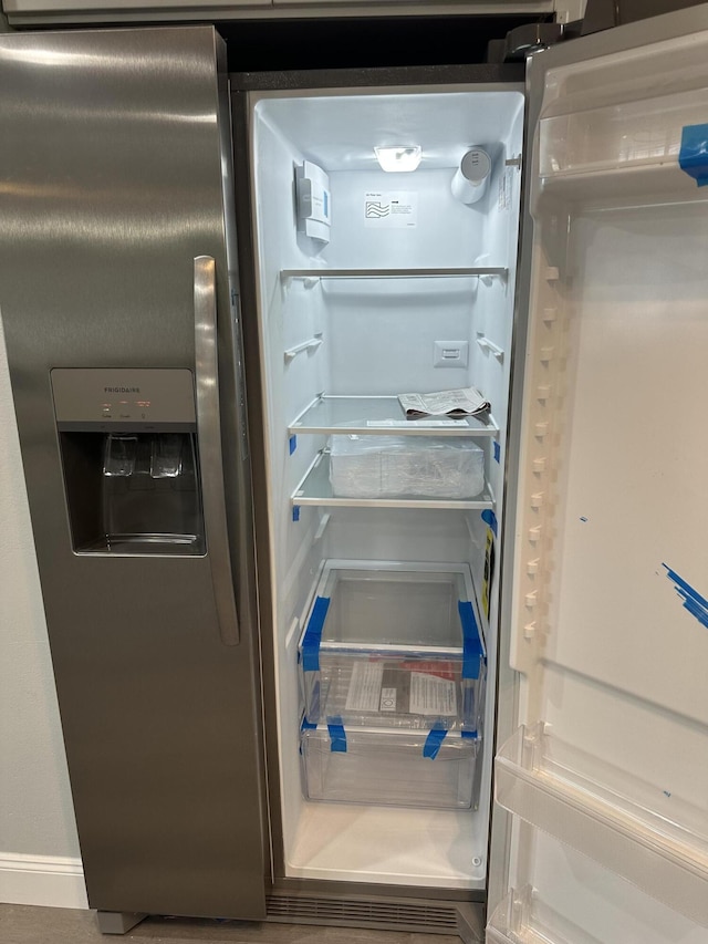 room details featuring stainless steel refrigerator with ice dispenser