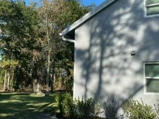 view of property exterior with a lawn