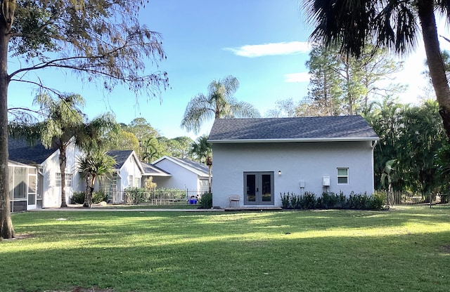 back of house with a lawn and french doors