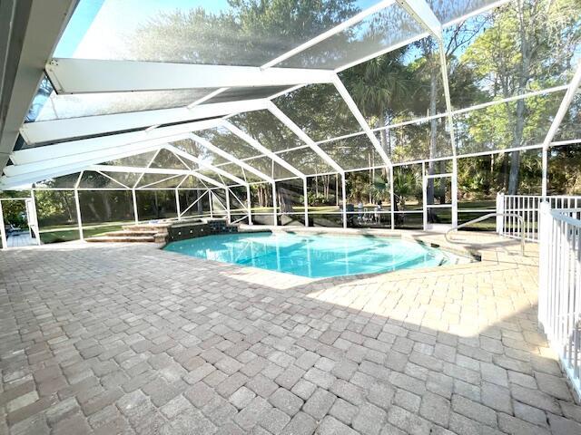 view of pool with a lanai and a patio