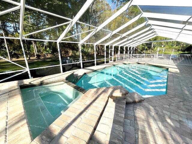 view of swimming pool with a lanai and a patio area