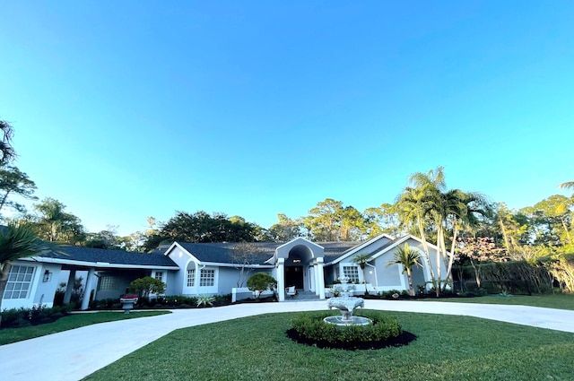 single story home featuring a front lawn