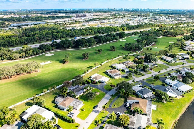 aerial view with golf course view and a water view