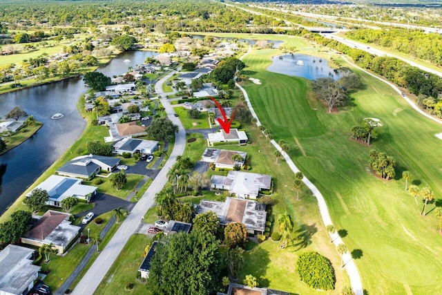 drone / aerial view with a water view, a residential view, and golf course view