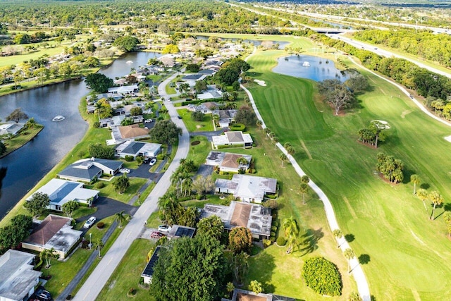 aerial view with view of golf course, a water view, and a residential view