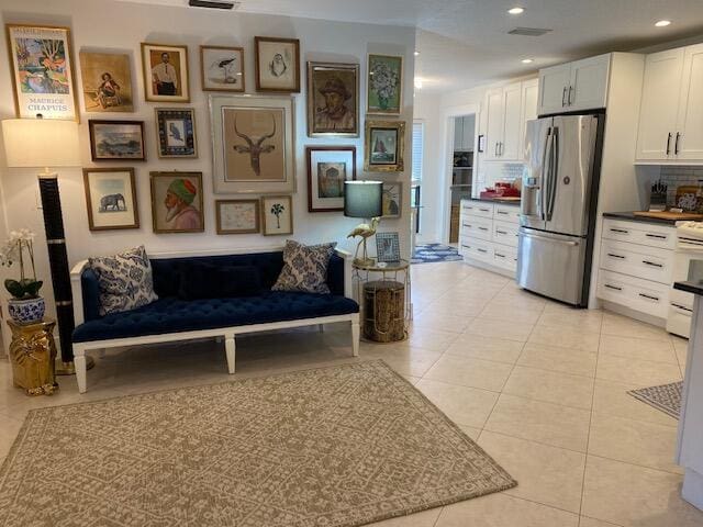 interior space featuring light tile patterned floors, visible vents, and recessed lighting