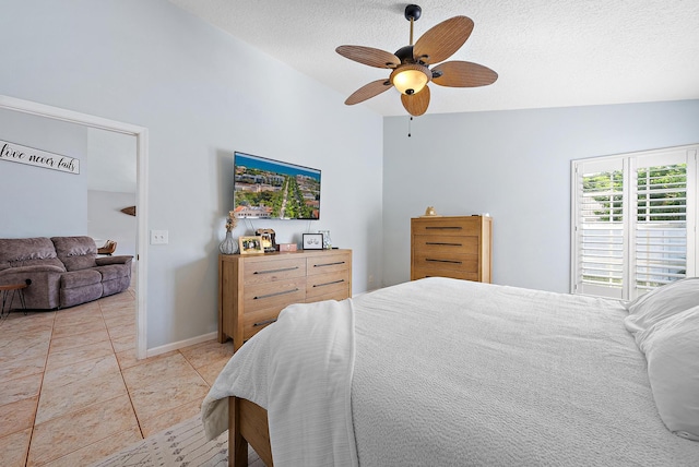 tiled bedroom featuring lofted ceiling, a textured ceiling, and ceiling fan