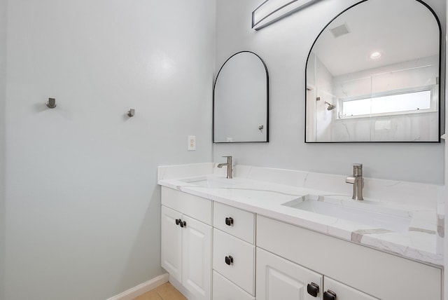 bathroom featuring walk in shower and vanity