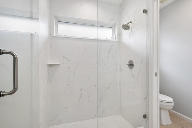 bathroom with tile patterned flooring, walk in shower, and toilet