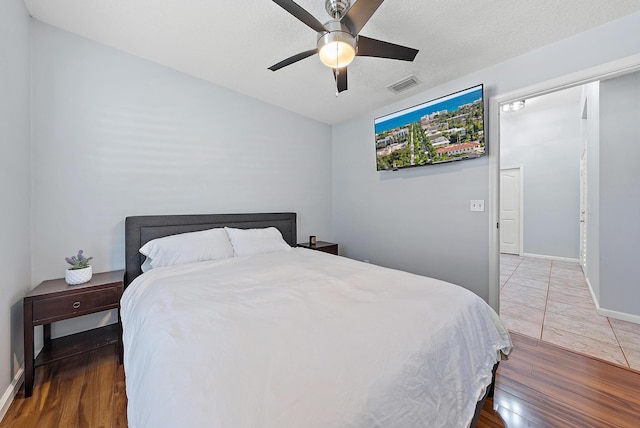 bedroom featuring dark hardwood / wood-style floors and ceiling fan