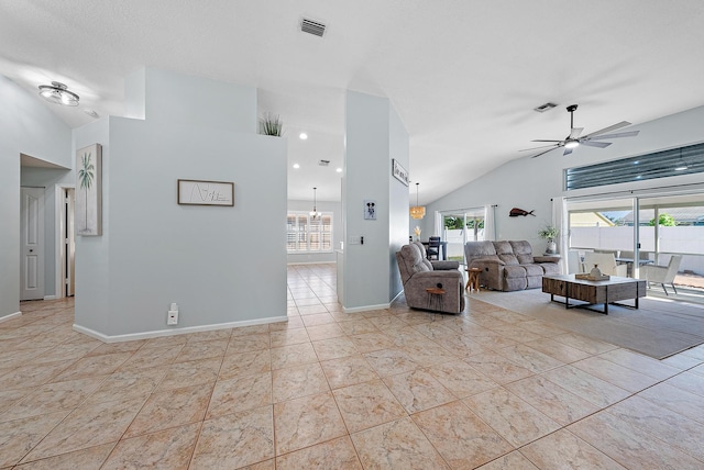 unfurnished living room with ceiling fan and high vaulted ceiling