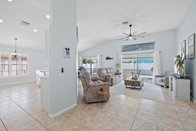 living room with light tile patterned floors, lofted ceiling, ceiling fan with notable chandelier, and plenty of natural light