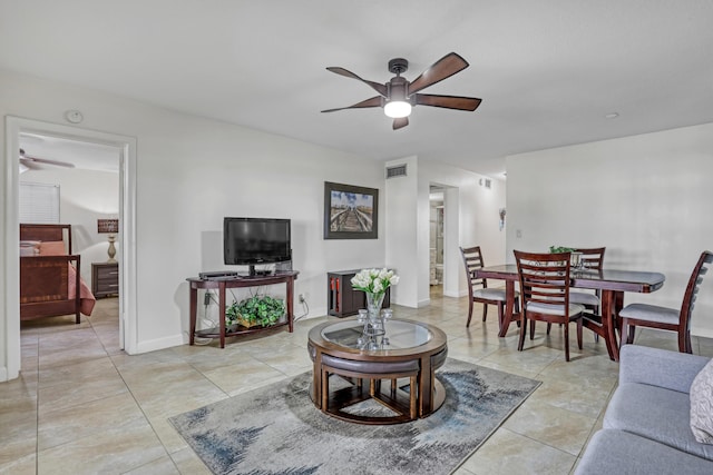 living room with ceiling fan and light tile patterned flooring