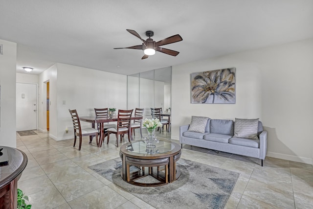 living room featuring ceiling fan and light tile patterned flooring