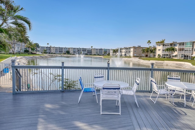 wooden terrace featuring a water view