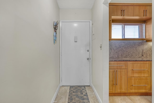 entryway with light tile patterned floors