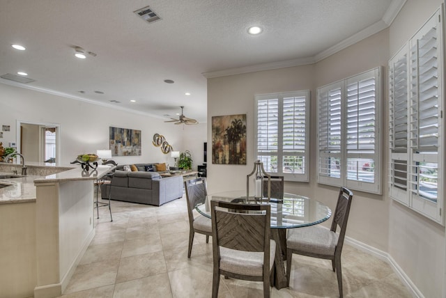 dining room featuring visible vents, ornamental molding, recessed lighting, a textured ceiling, and a ceiling fan