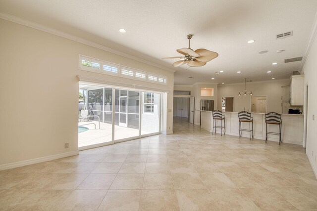 kitchen with stainless steel appliances, white cabinetry, a kitchen island, and wine cooler