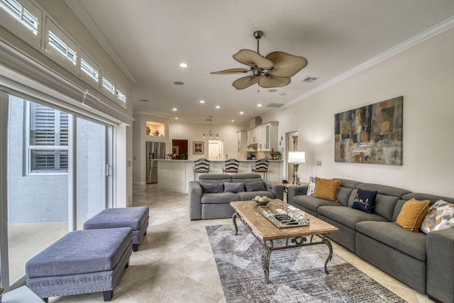 living room featuring light tile patterned floors, ornamental molding, and ceiling fan