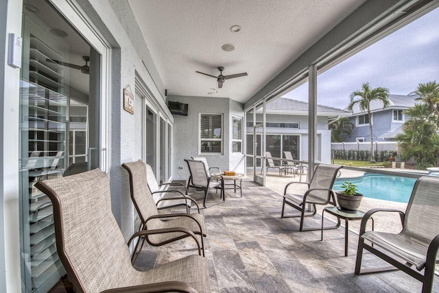 exterior space featuring fence, a ceiling fan, and a fenced in pool