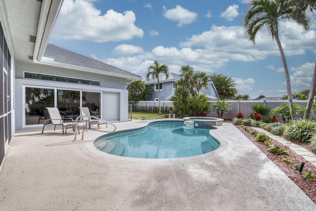 view of swimming pool featuring a patio, a pool with connected hot tub, and fence