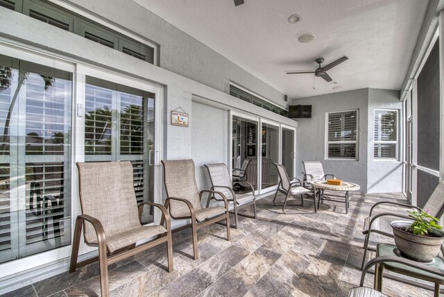 view of swimming pool with a sunroom, a patio, central air condition unit, and an in ground hot tub