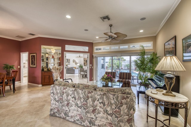 living room with visible vents, baseboards, and crown molding