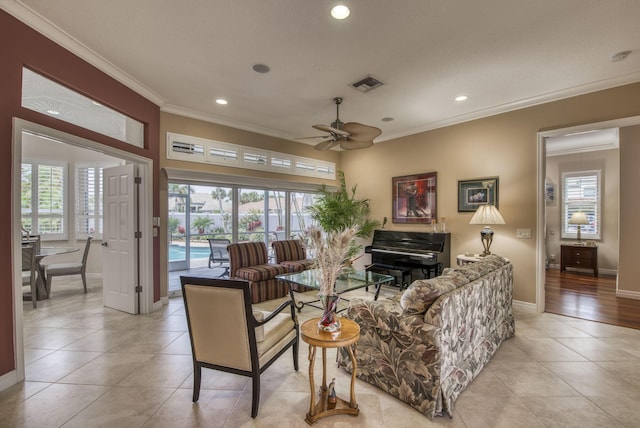 living room featuring crown molding, a healthy amount of sunlight, and visible vents