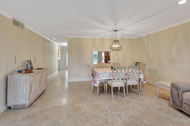 dining area featuring ornamental molding and an inviting chandelier