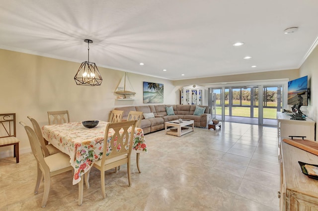 dining space with ornamental molding and a chandelier