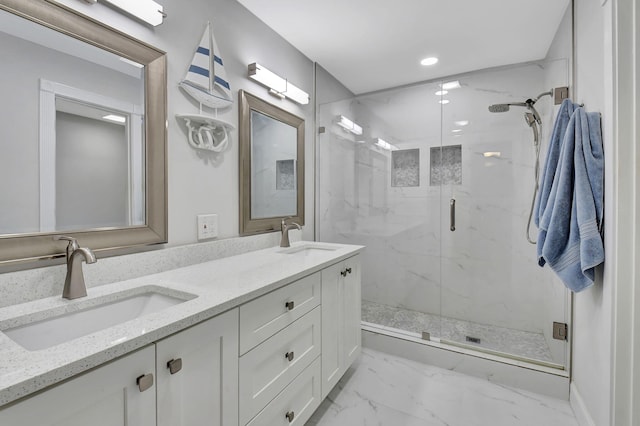 bathroom featuring vanity and a shower with shower door