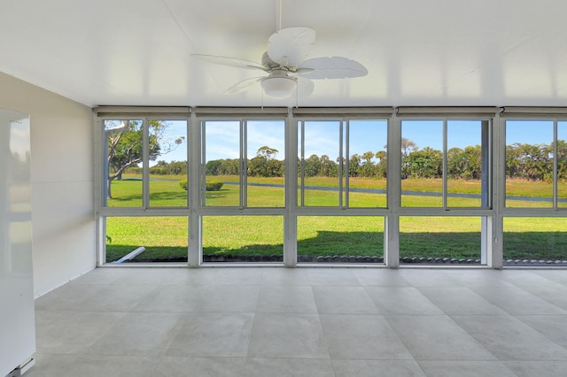 unfurnished sunroom with a wealth of natural light and ceiling fan