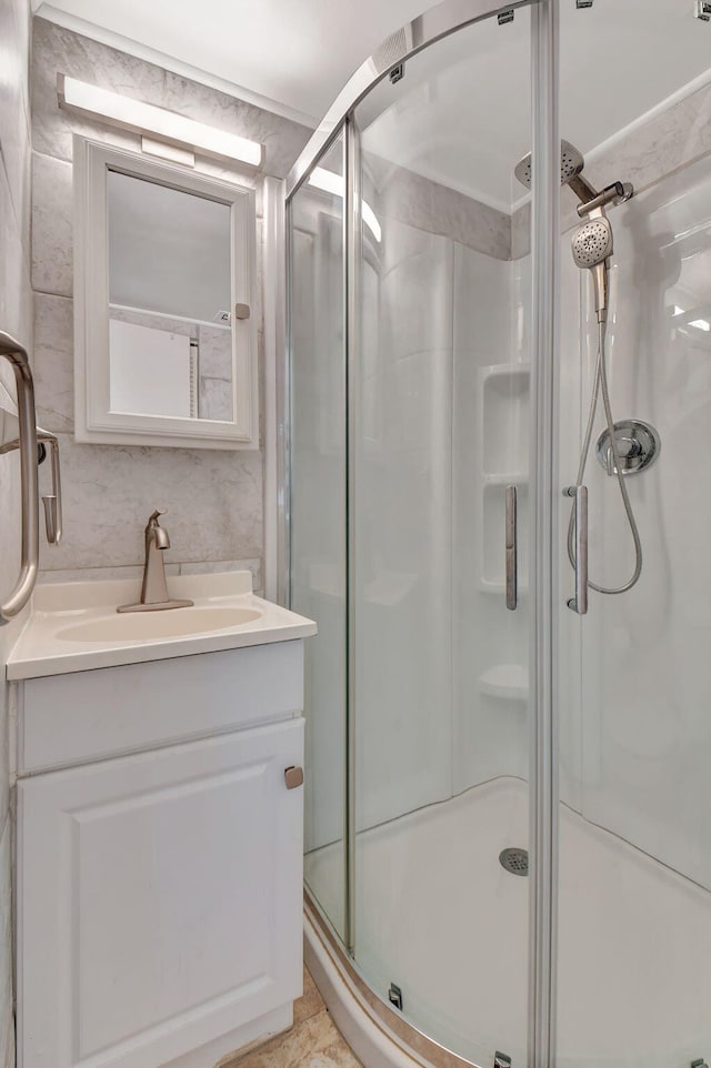 bathroom with vanity and a shower with door