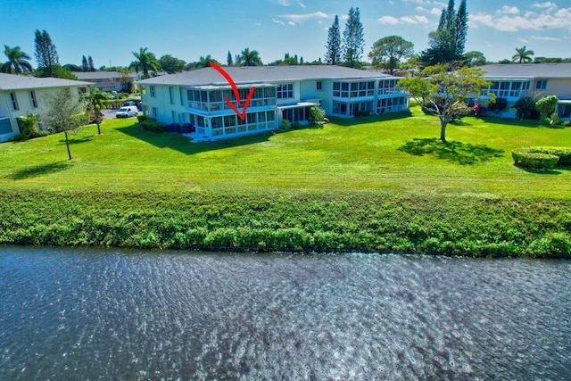 view of front facade featuring a water view and a front yard