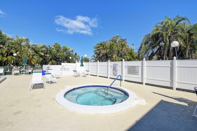 view of pool featuring a hot tub and a patio area