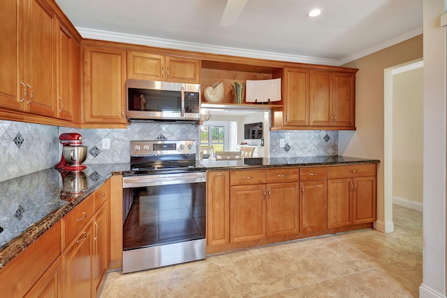 kitchen featuring tasteful backsplash, ornamental molding, stainless steel appliances, and dark stone countertops