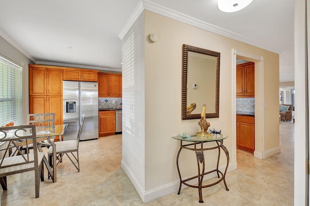 kitchen featuring crown molding, decorative backsplash, and appliances with stainless steel finishes