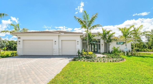 view of front of home featuring a garage and a front lawn